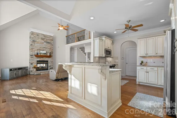 a view interior of a house with wooden floor fireplace and windows