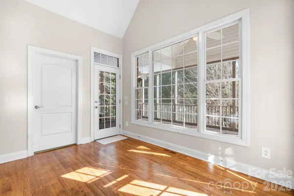 a view of a livingroom with wooden floor and a ceiling fan