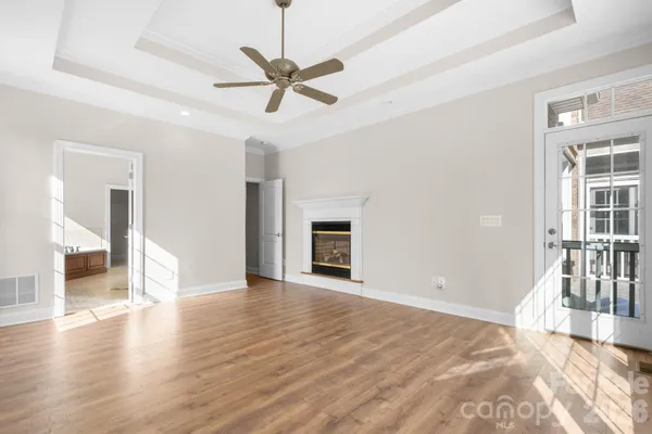 a view of an empty room with a fireplace and a window