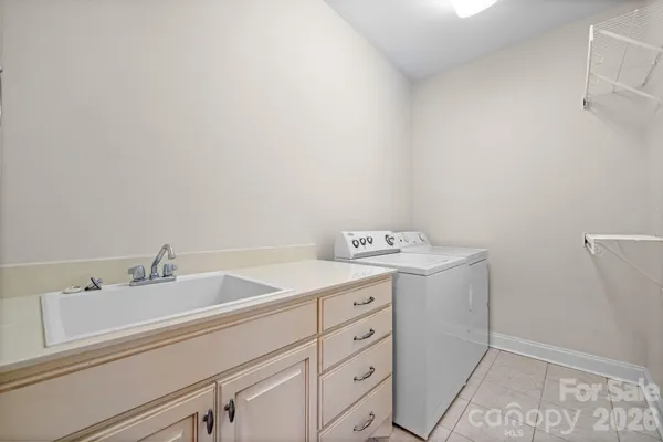 a kitchen with granite countertop a sink stove and refrigerator