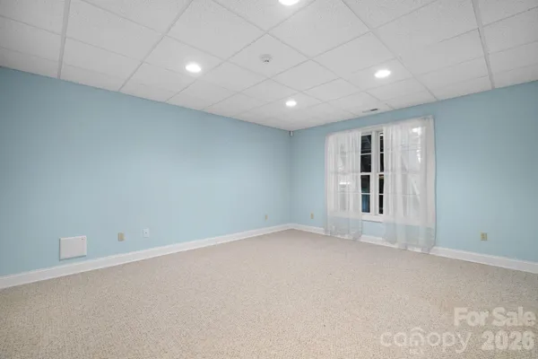 a view of a room with balcony and floor to ceiling window