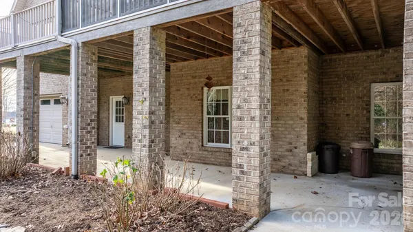 front view of a brick house with a small yard