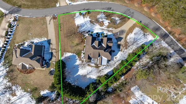 an aerial view of a house with a swimming pool