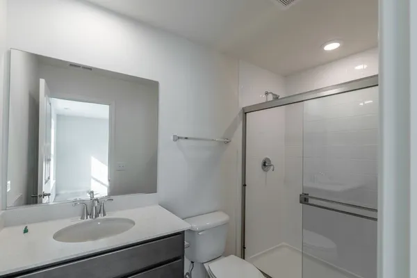 a bathroom with a toilet a sink and mirror