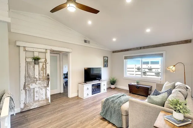 a living room with furniture a fireplace and a flat screen tv