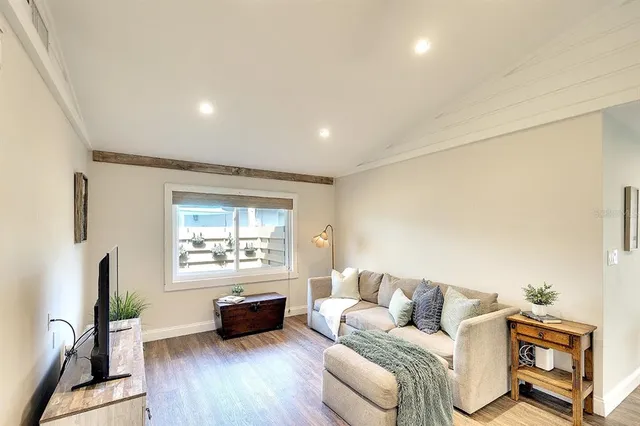 a living room with furniture window and wooden floor