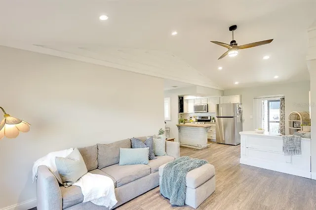 a living room with furniture and kitchen view