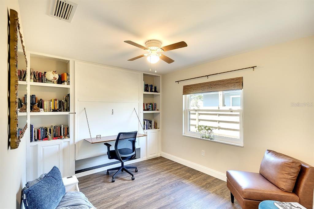 2224 Eugene Street Sarasota, FL 34231 - Photo 20 of 45 a workspace with furniture and a book shelf