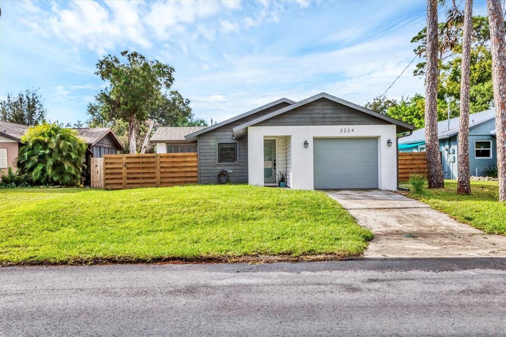 2224 Eugene Street Sarasota, FL 34231 - Photo 2 of 45 a front view of a house with a garden and yard