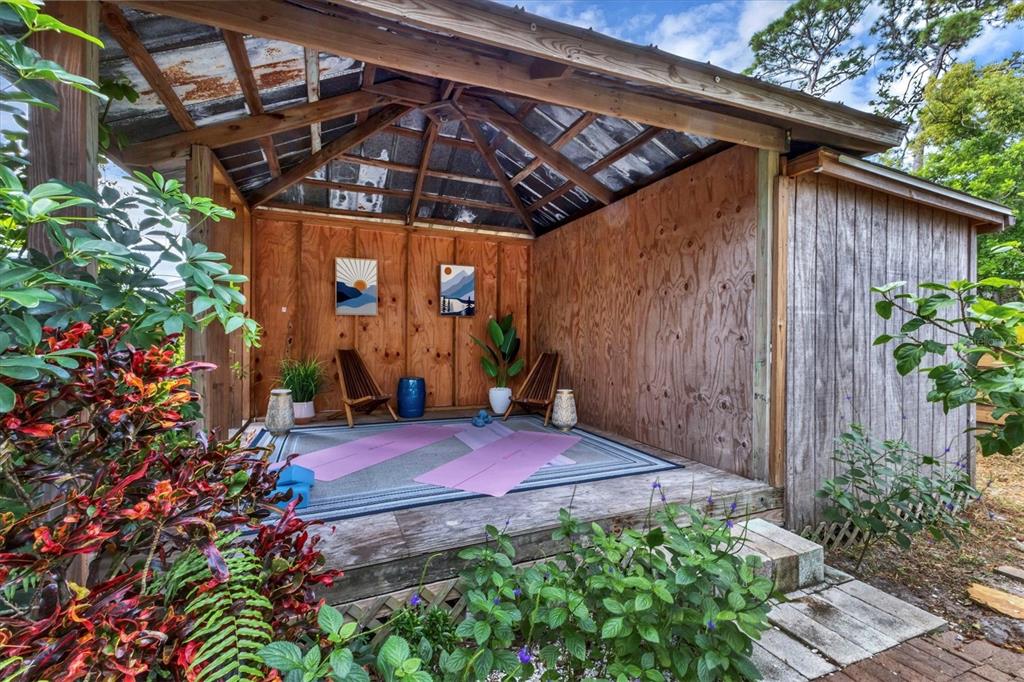 2224 Eugene Street Sarasota, FL 34231 - Photo 35 of 45 a view of a backyard with plants and a tree