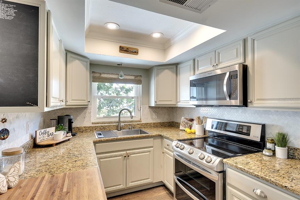 2224 Eugene Street Sarasota, FL 34231 - Photo 8 of 45 a kitchen with a sink stove top oven and microwave