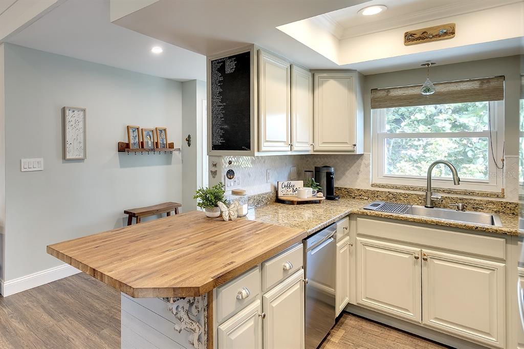 2224 Eugene Street Sarasota, FL 34231 - Photo 9 of 45 a kitchen with a sink window and cabinets