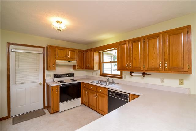 5002 East Robertson Road Cross Plains, TN 37049 - Photo 8 of 20 a kitchen with stainless steel appliances granite countertop a stove a sink and a refrigerator