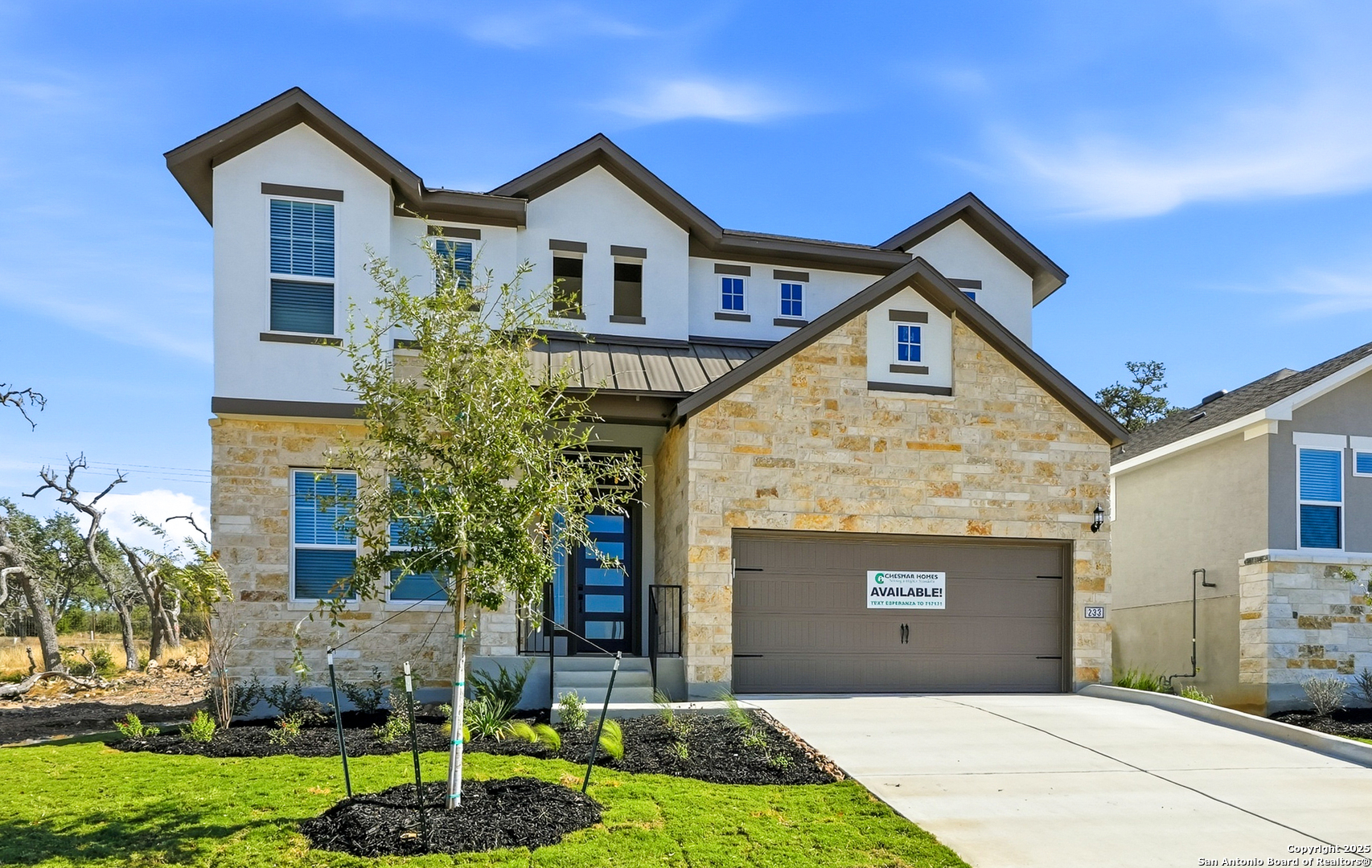 a front view of a house with a yard and garage
