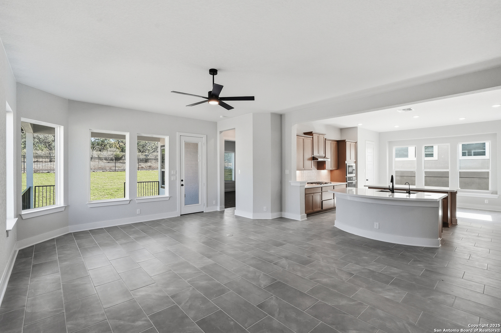 233 Sasparilla Boerne, TX 78006 - Photo 12 of 60 a view of a living room and kitchen with furniture and windows