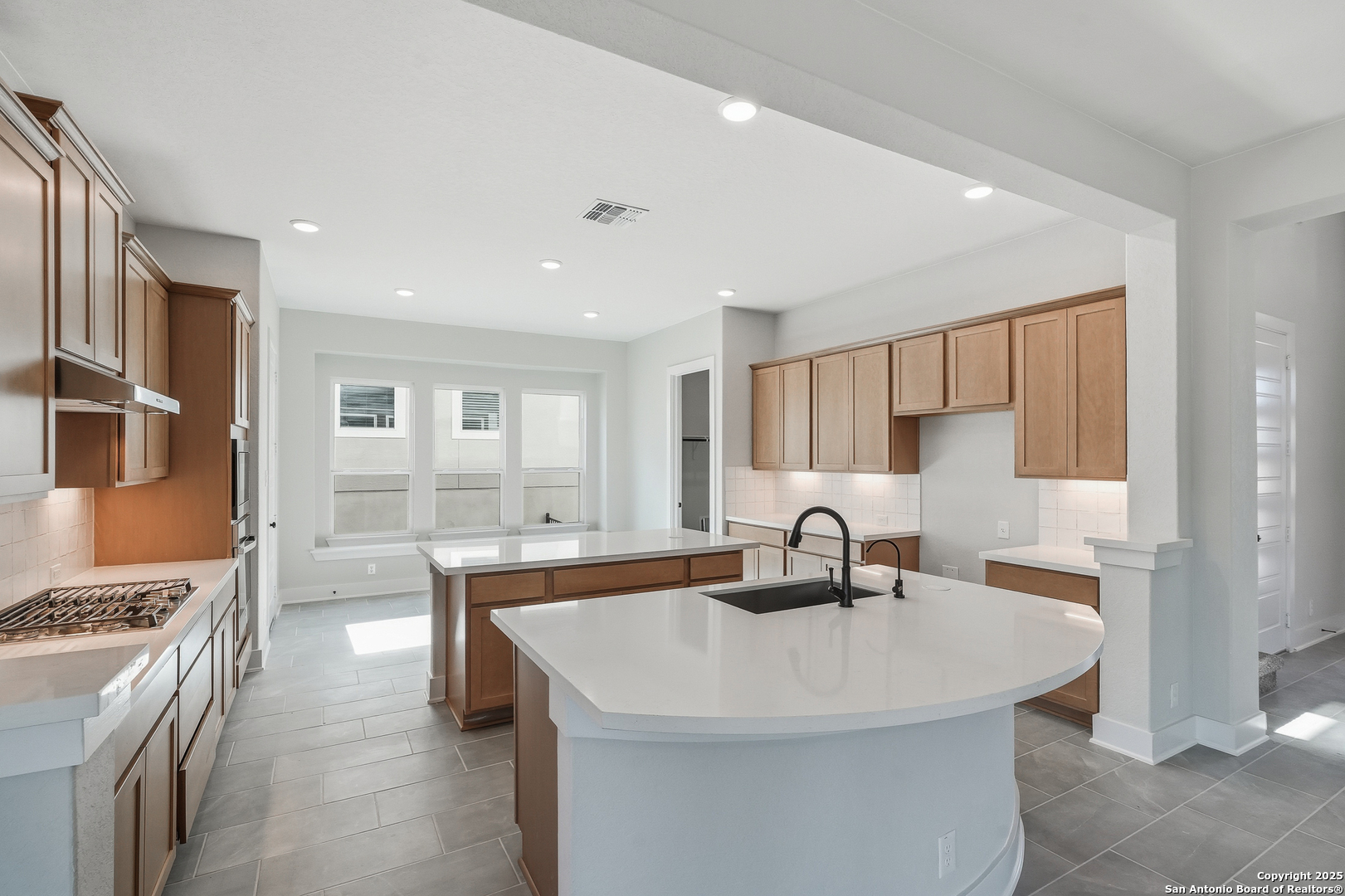 233 Sasparilla Boerne, TX 78006 - Photo 15 of 60 a kitchen with stainless steel appliances a sink and a stove
