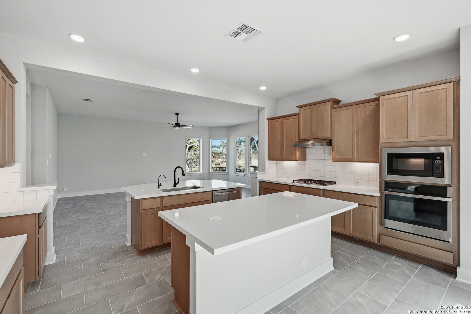 233 Sasparilla Boerne, TX 78006 - Photo 19 of 60 a kitchen with a stove a sink and a refrigerator