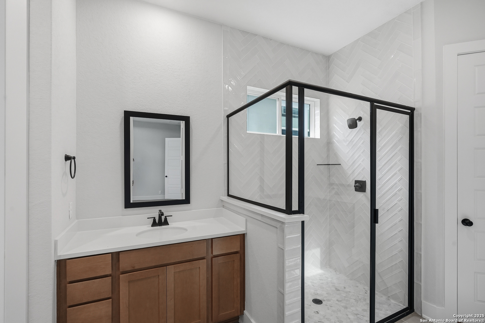 233 Sasparilla Boerne, TX 78006 - Photo 25 of 60 a bathroom with a double vanity sink mirror and shower