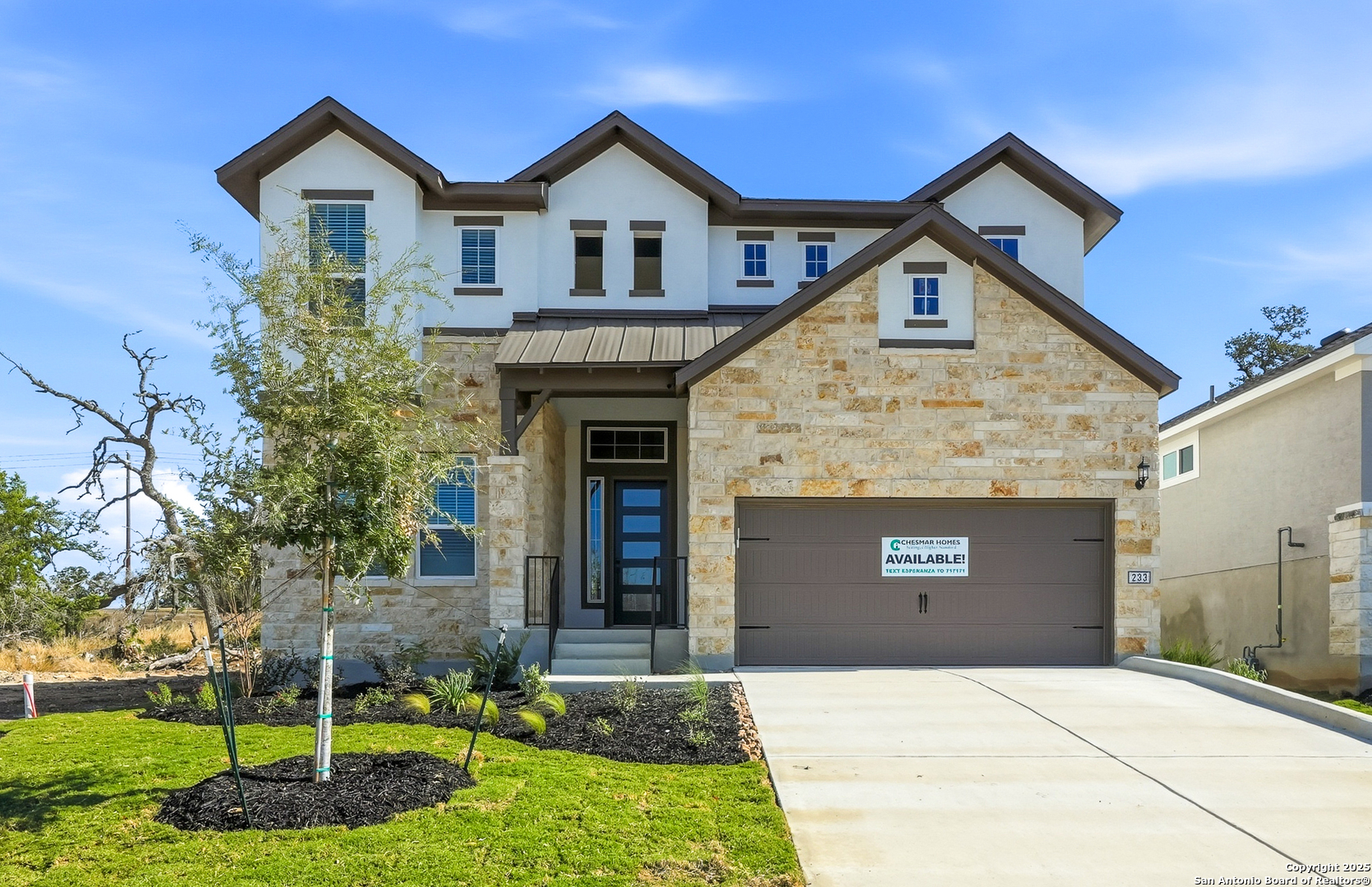 233 Sasparilla Boerne, TX 78006 - Photo 3 of 60 a front view of a house with a yard and garage