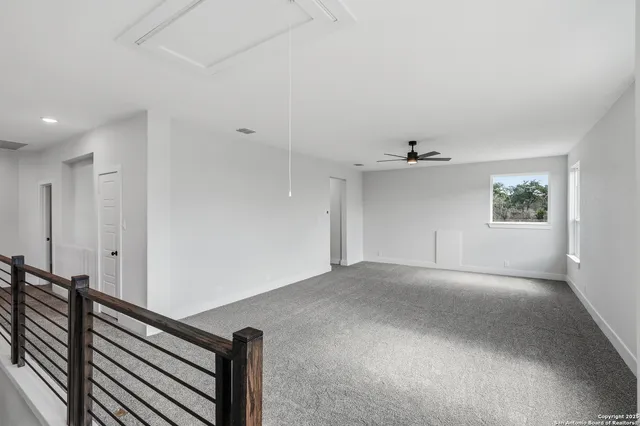 a bathroom with a granite countertop sink a toilet and a mirror