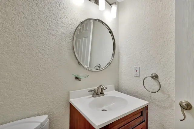 a view of a hallway with wooden floor and stairs
