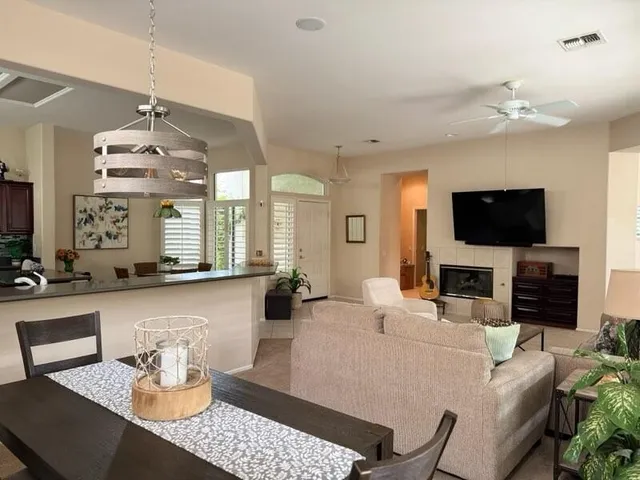 a living room with fireplace furniture and a flat screen tv