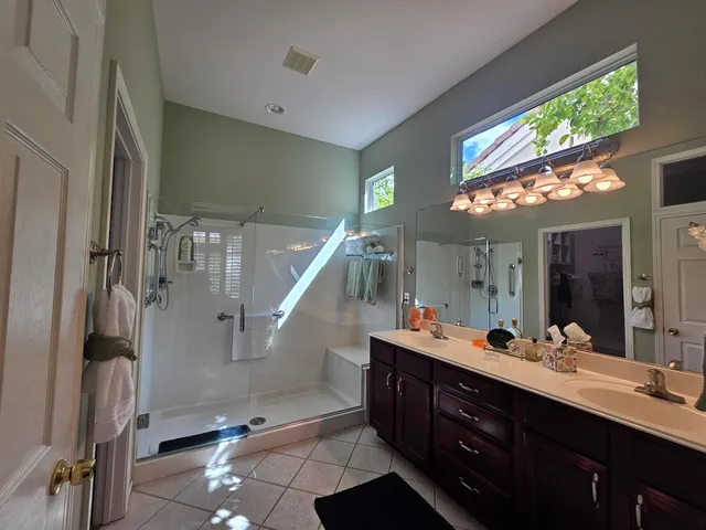 a bathroom with a double vanity sink and a mirror