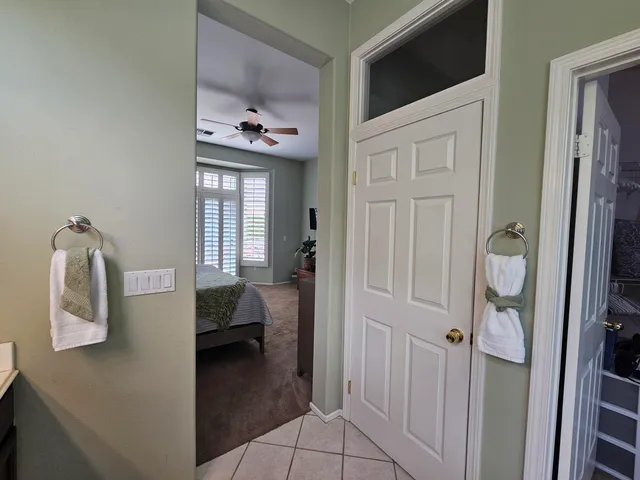 a view of a hallway to a livingroom with furniture