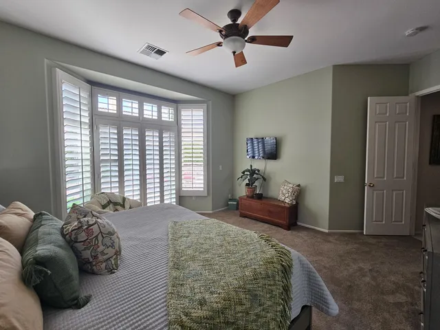 a spacious bedroom with a bed and a couch