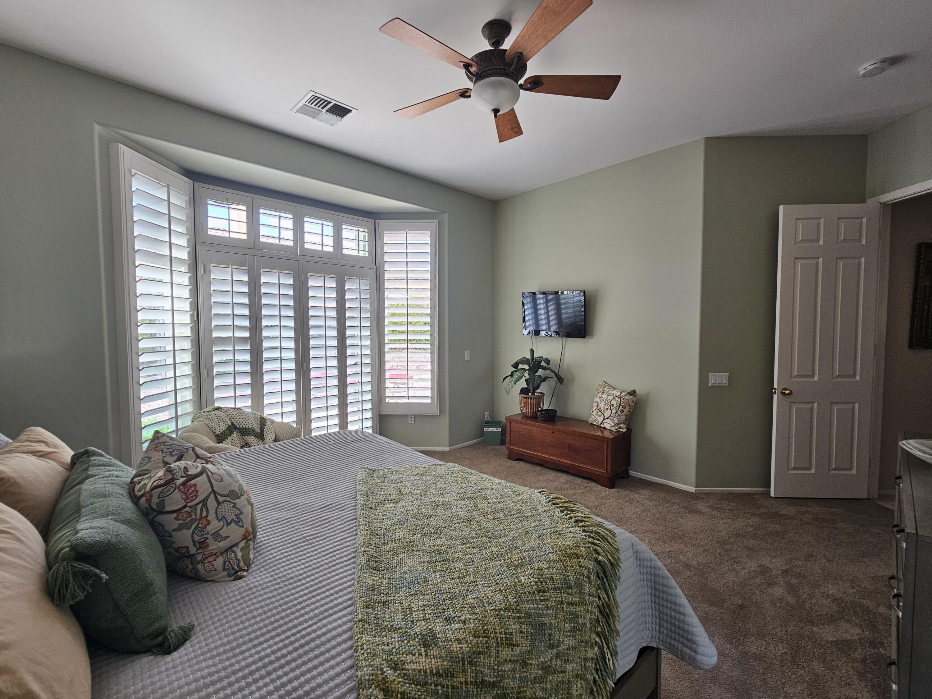 35875 Donny Circle Palm Desert, CA 92211 - Photo 23 of 50 a spacious bedroom with a bed and a couch