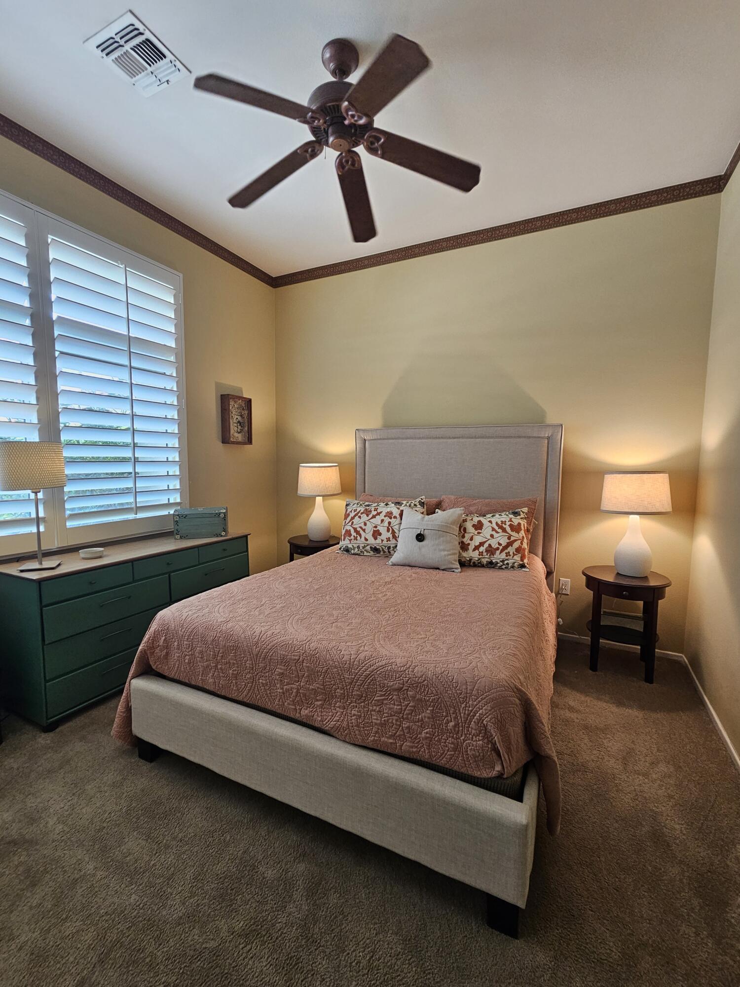 35875 Donny Circle Palm Desert, CA 92211 - Photo 27 of 50 a bedroom with a bed and a chandelier