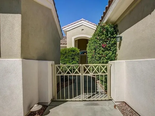 a front view of a house with plants