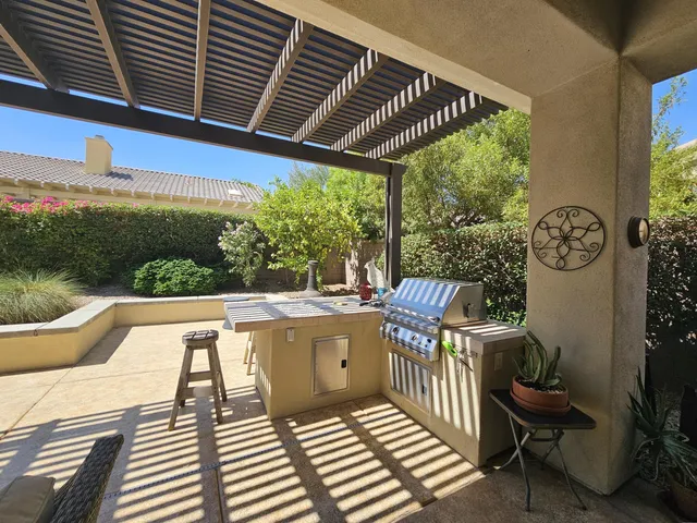 a view of a chairs and table in the balcony