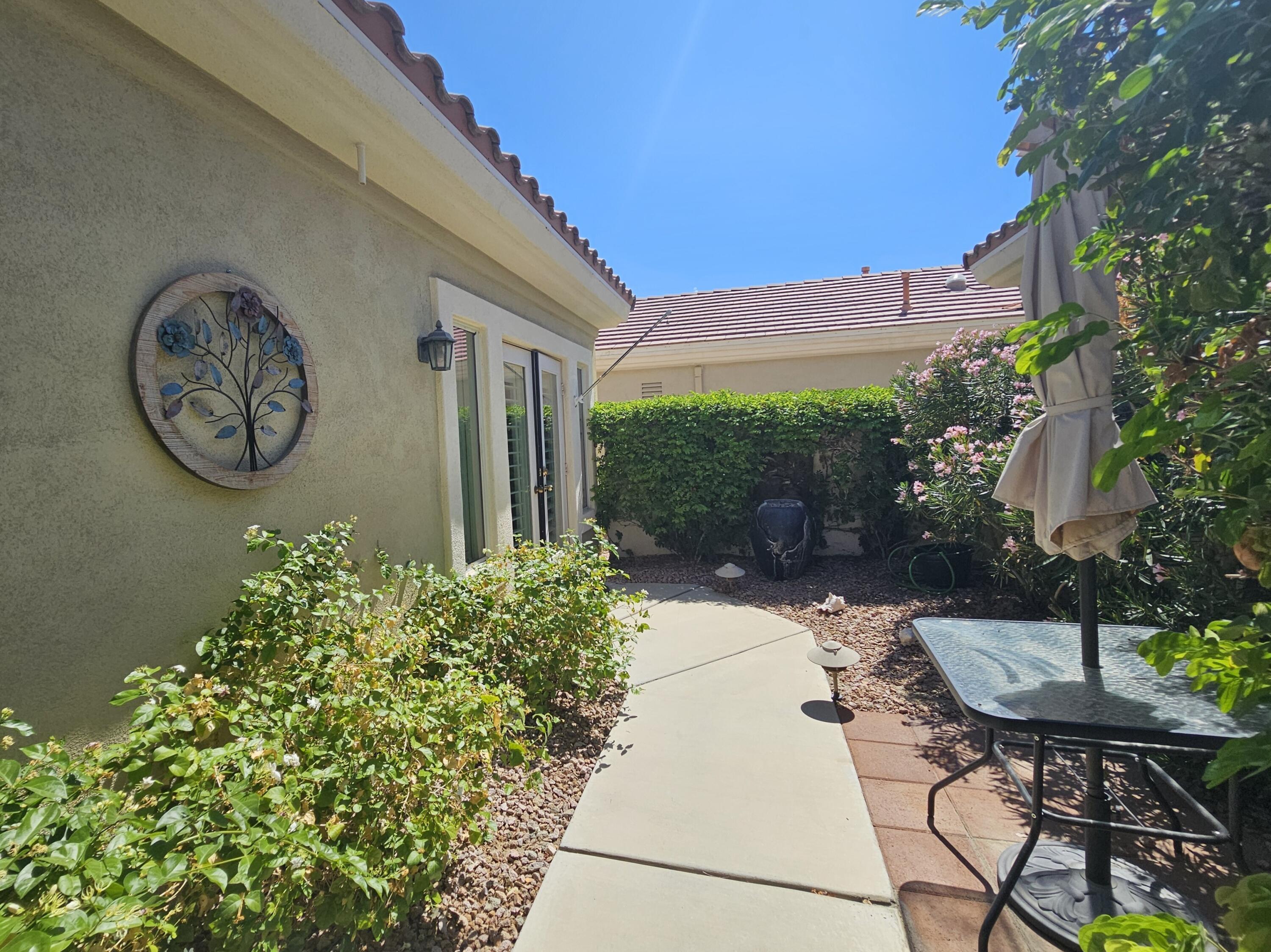35875 Donny Circle Palm Desert, CA 92211 - Photo 37 of 50 a backyard of a house with table and chairs