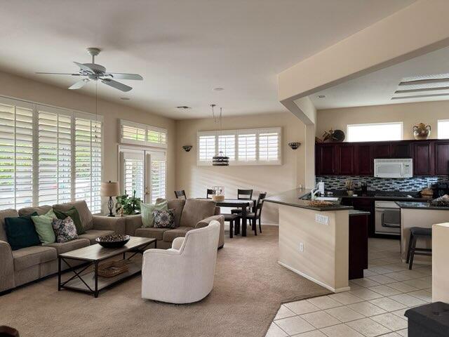 35875 Donny Circle Palm Desert, CA 92211 - Photo 7 of 50 a living room with furniture kitchen view and a large window