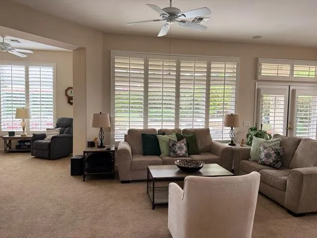 a living room with furniture and a large window