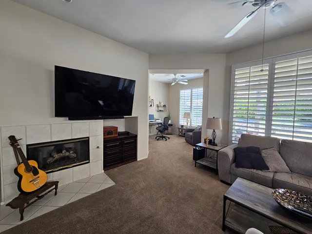 a living room with furniture flat screen tv and a fireplace