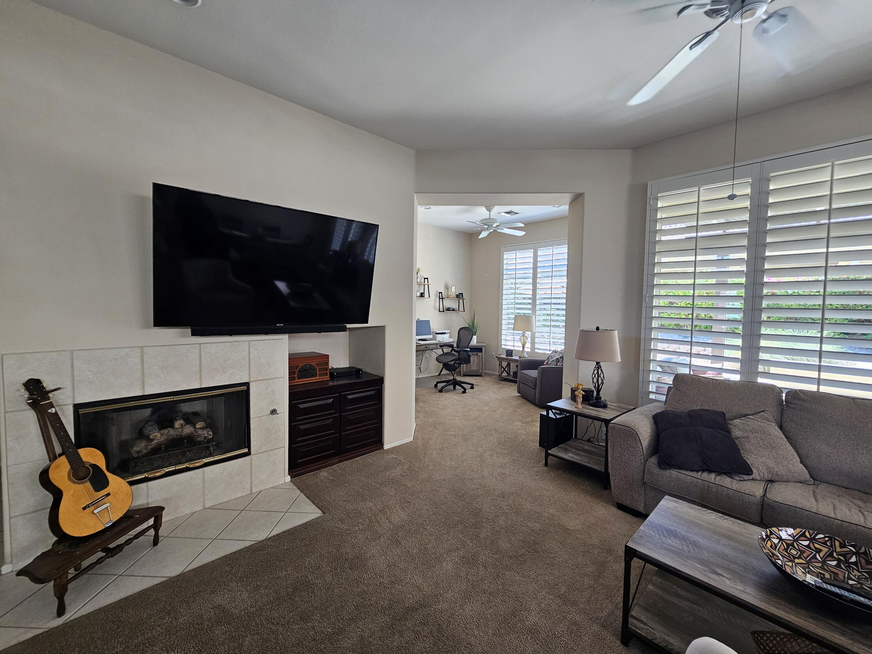 35875 Donny Circle Palm Desert, CA 92211 - Photo 9 of 50 a living room with furniture flat screen tv and a fireplace