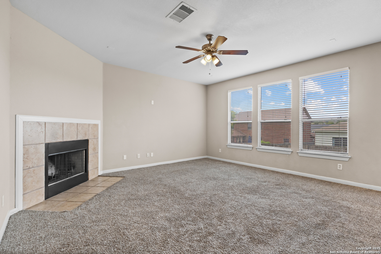 156 Springtree Bluff Cibolo, TX 78108 - Photo 14 of 42 a view of an empty room with chandelier fan and fire place