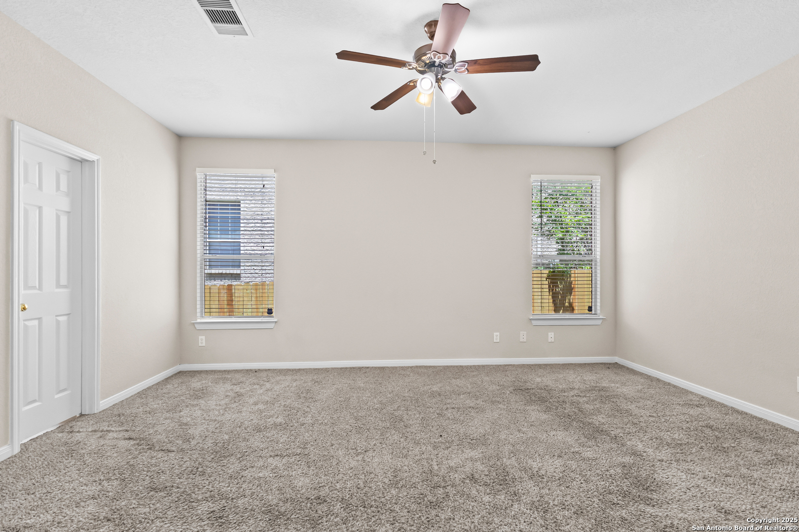 156 Springtree Bluff Cibolo, TX 78108 - Photo 24 of 42 an empty room with windows and fan