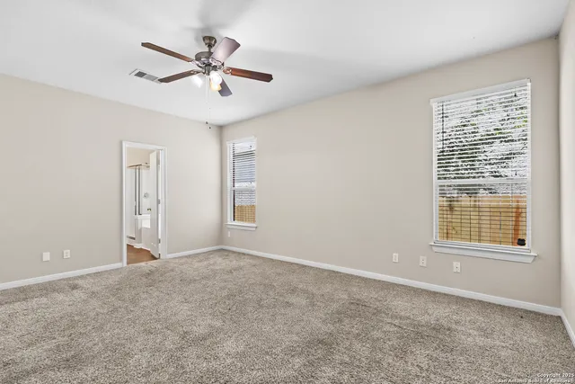 a spacious bathroom with a double vanity sink mirror and double