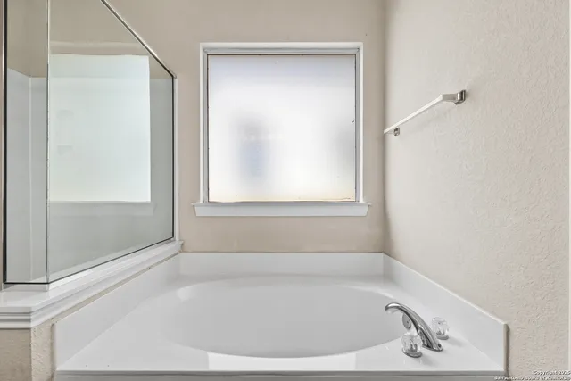 a bathroom with a bathtub and a shower