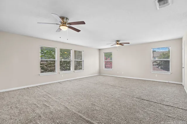 a view of a livingroom with a ceiling fan and window