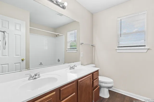 a bathroom with a sink toilet and a mirror