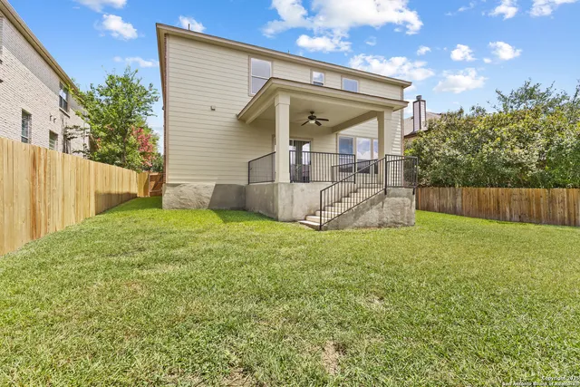 a view of a house with a yard and sitting area
