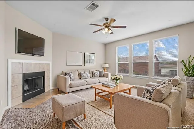 a bedroom with a large bed a chandelier and a couch