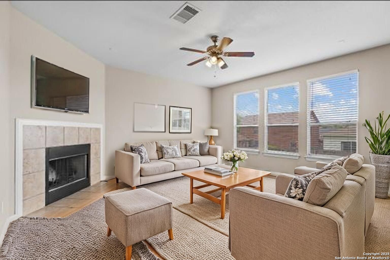 156 Springtree Bluff Cibolo, TX 78108 - Photo 7 of 42 a living room with furniture a fireplace and a flat screen tv