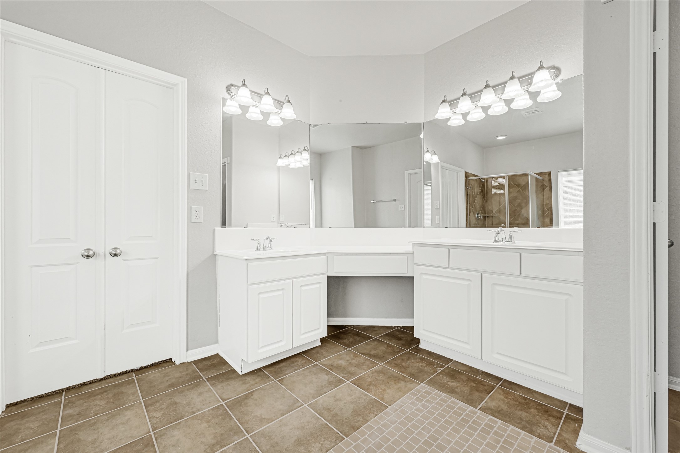 4702 Sedgewood Drive Rosenberg, TX 77471 - Photo 21 of 24 Beautiful modern bathroom featuring a double vanity with ample cabinet space, a large mirror with overhead lighting, and a shower-tub combo with tiled walls. The neutral tones create a clean and inviting atmosphere.
