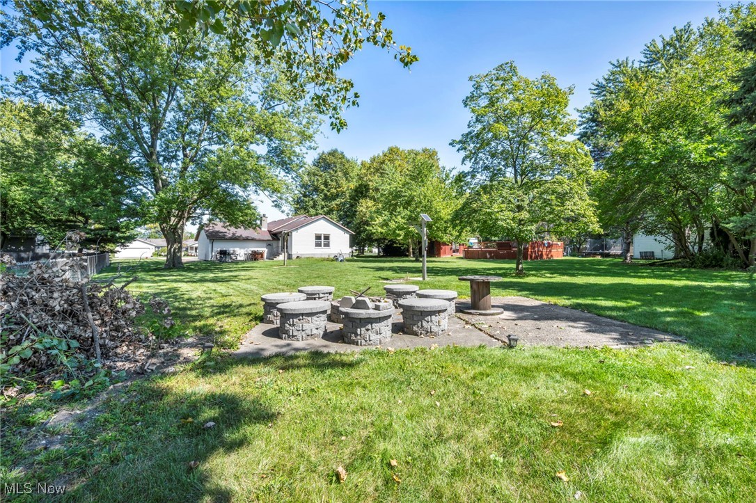 5704 McCartney Road Sandusky, OH 44870 - Photo 7 of 50 View of grassy yard with a patio and view of wooded area