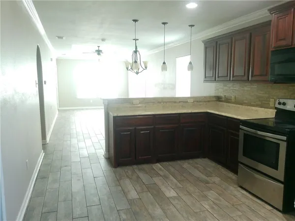 a kitchen with stainless steel appliances granite countertop a sink and a stove